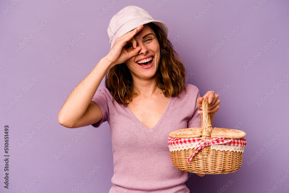Young caucasian woman going on a picnic isolated on purple background excited keeping ok gesture on eye. Young caucasian woman going on a picnic isolated on purple background excited keeping ok gesture on eye.