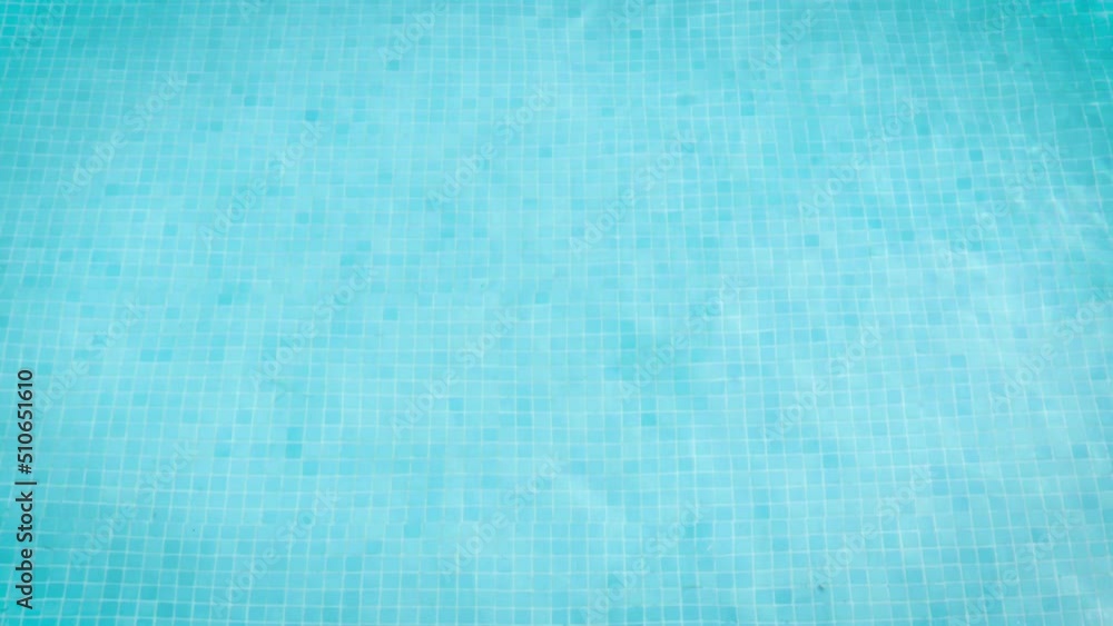 moving waves of blue tiled swimming pool water during the day moving waves of blue tiled swimming pool water during the day