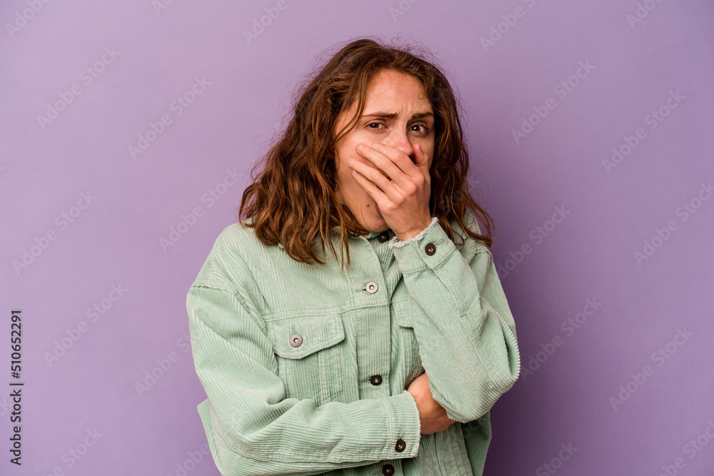 Young caucasian woman isolated on purple background scared and afraid. Young caucasian woman isolated on purple background scared and afraid.