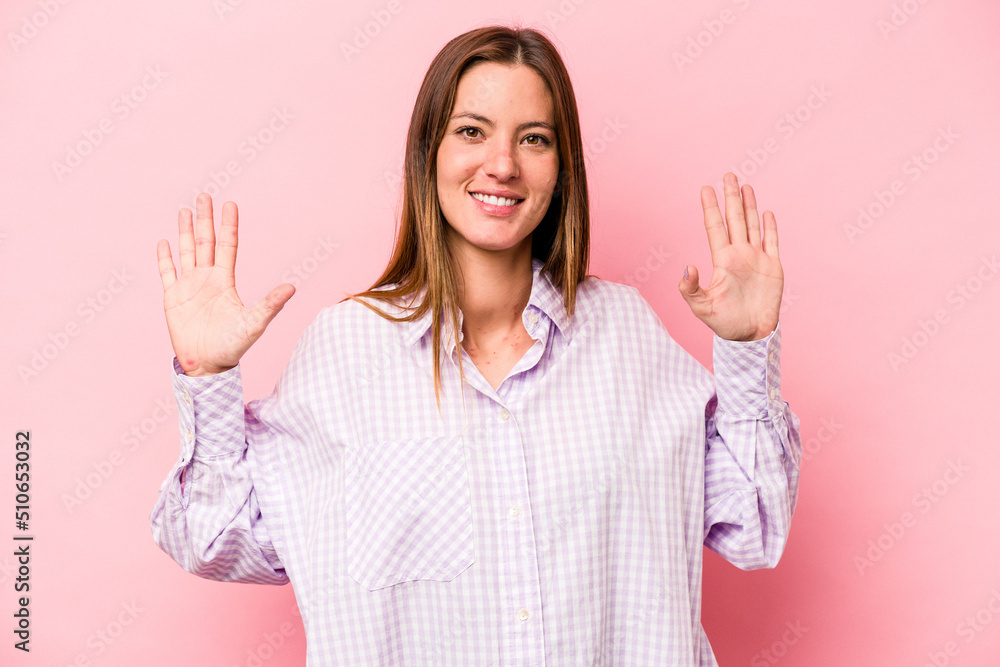 Young caucasian pregnant woman isolated on white background showing number ten with hands. Young caucasian pregnant woman isolated on white background showing number ten with hands.