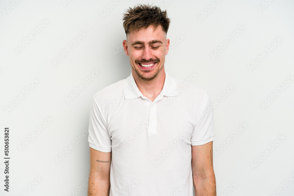 Young caucasian man isolated on white background laughs and closes eyes, feels relaxed and happy. Young caucasian man isolated on white background laughs and closes eyes, feels relaxed and happy.