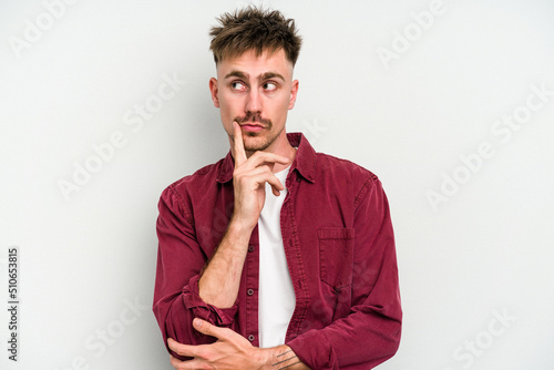 Young caucasian man isolated on white background contemplating  planning a strategy  thinking about the way of a business.