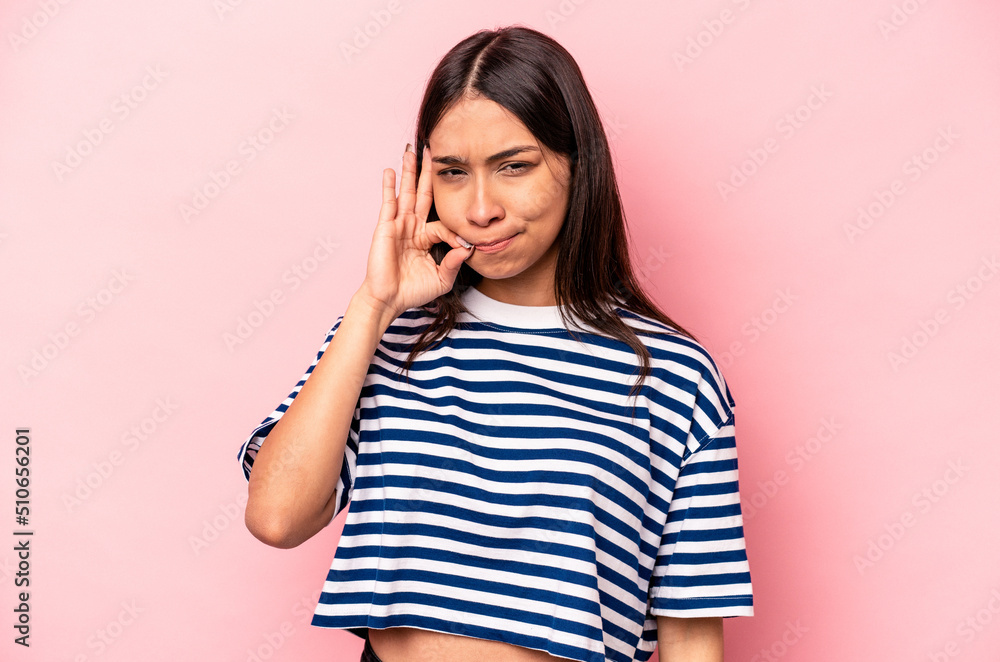 Young hispanic woman isolated on pink background with fingers on lips keeping a secret. Young hispanic woman isolated on pink background with fingers on lips keeping a secret.