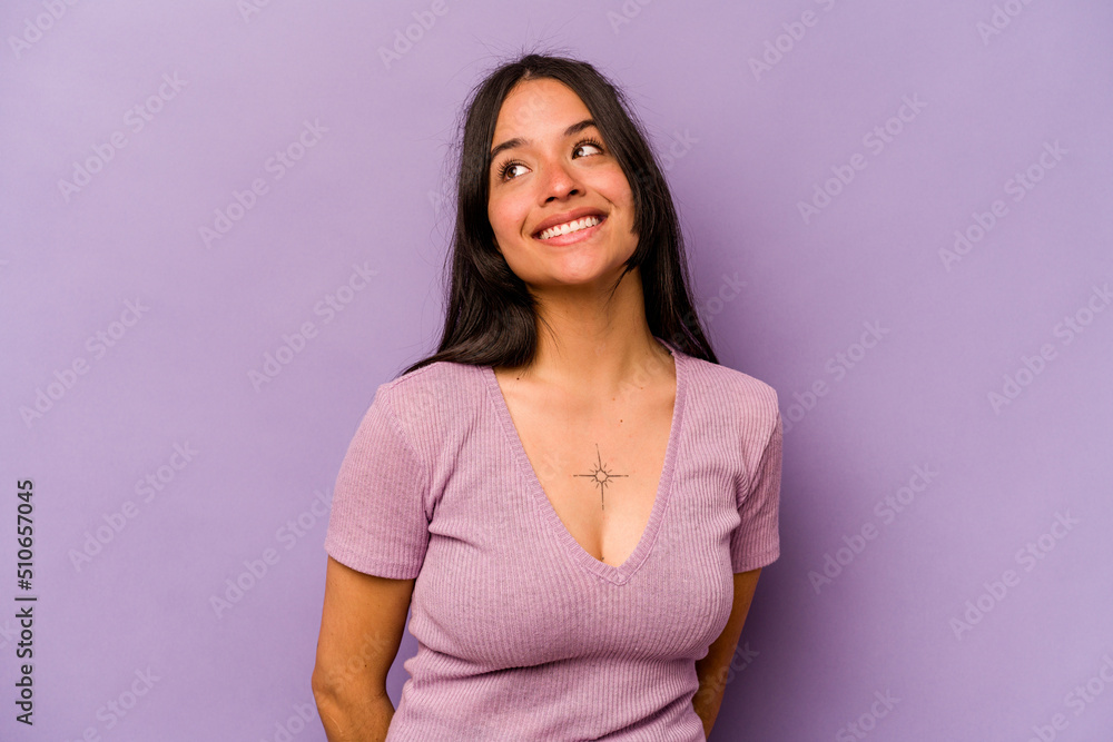 Young hispanic woman isolated on purple background relaxed and happy laughing, neck stretched showing teeth. Young hispanic woman isolated on purple background relaxed and happy laughing, neck stretched showing teeth.