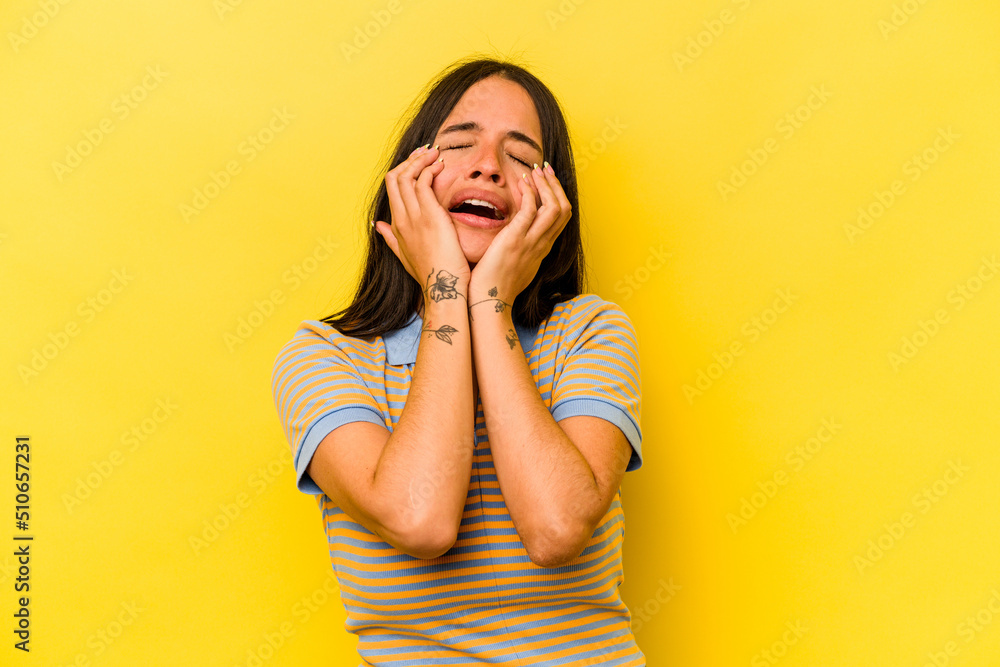 Young hispanic woman isolated on yellow background whining and crying disconsolately. Young hispanic woman isolated on yellow background whining and crying disconsolately.