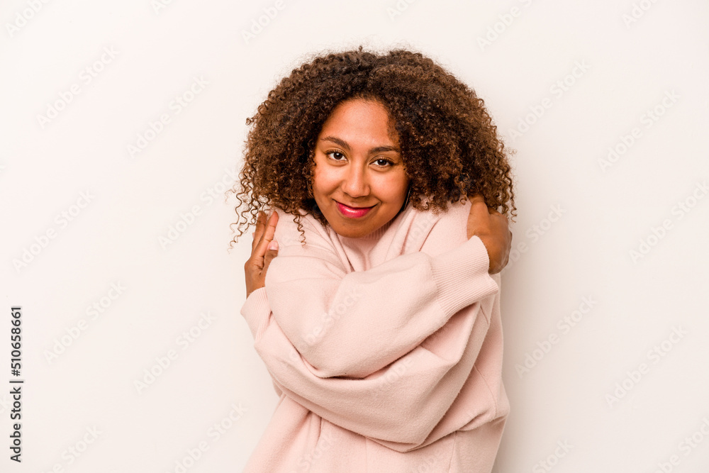 Young African American woman isolated on white background hugs, smiling carefree and happy. Young African American woman isolated on white background hugs, smiling carefree and happy.