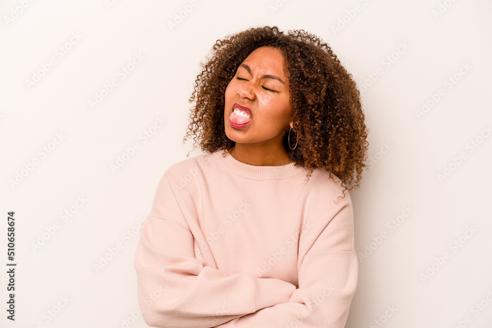 Young African American woman isolated on white background funny and friendly sticking out tongue. Young African American woman isolated on white background funny and friendly sticking out tongue.