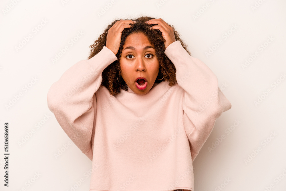 Young African American woman isolated on white background surprised and shocked. Young African American woman isolated on white background surprised and shocked.