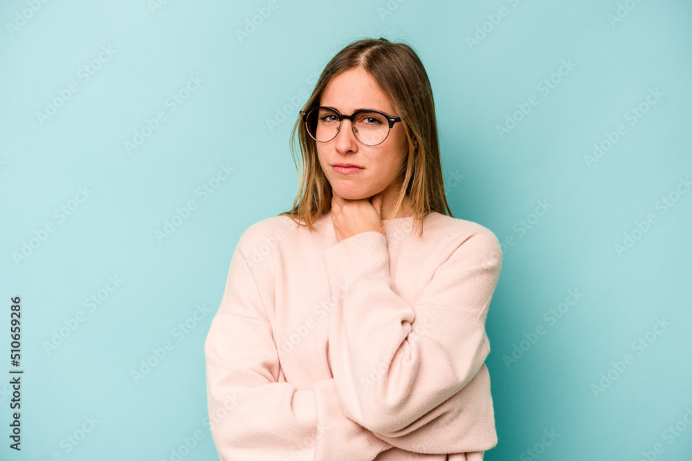 Young caucasian woman isolated on blue background suffers pain in throat due a virus or infection.