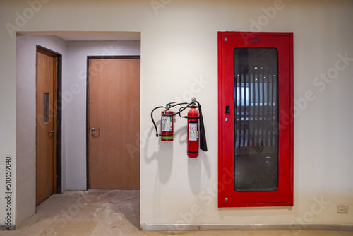 Foto Fire extinguisher and gas pump system on the wall