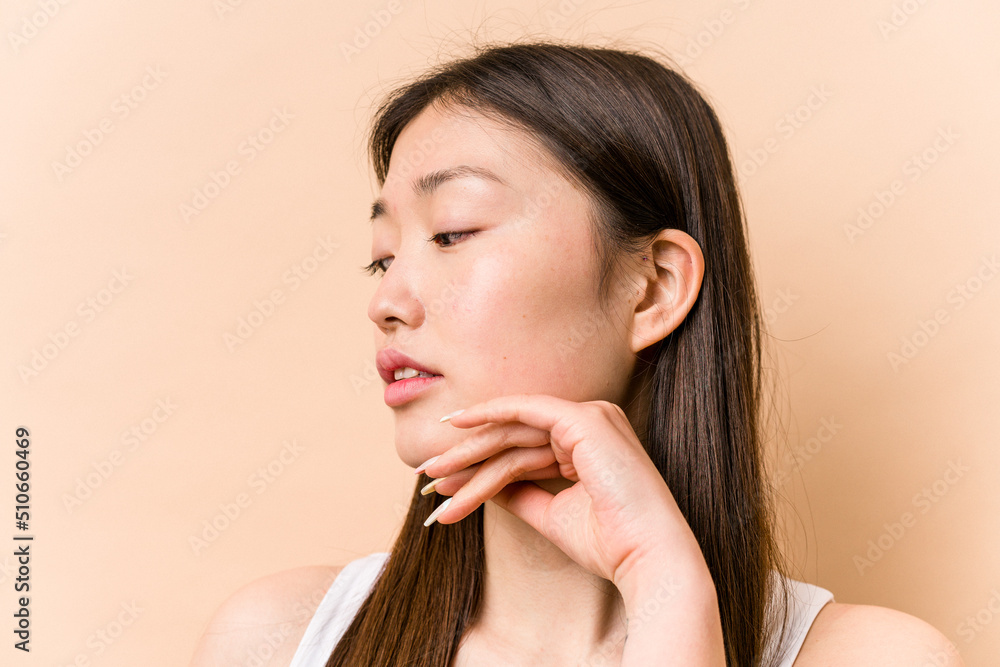 Young portrait asian woman isolated on beige background Young portrait asian woman isolated on beige background