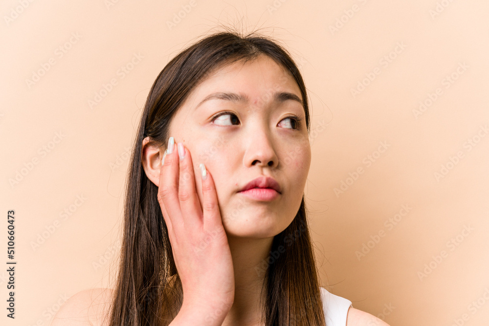 Young portrait asian woman isolated on beige background Young portrait asian woman isolated on beige background