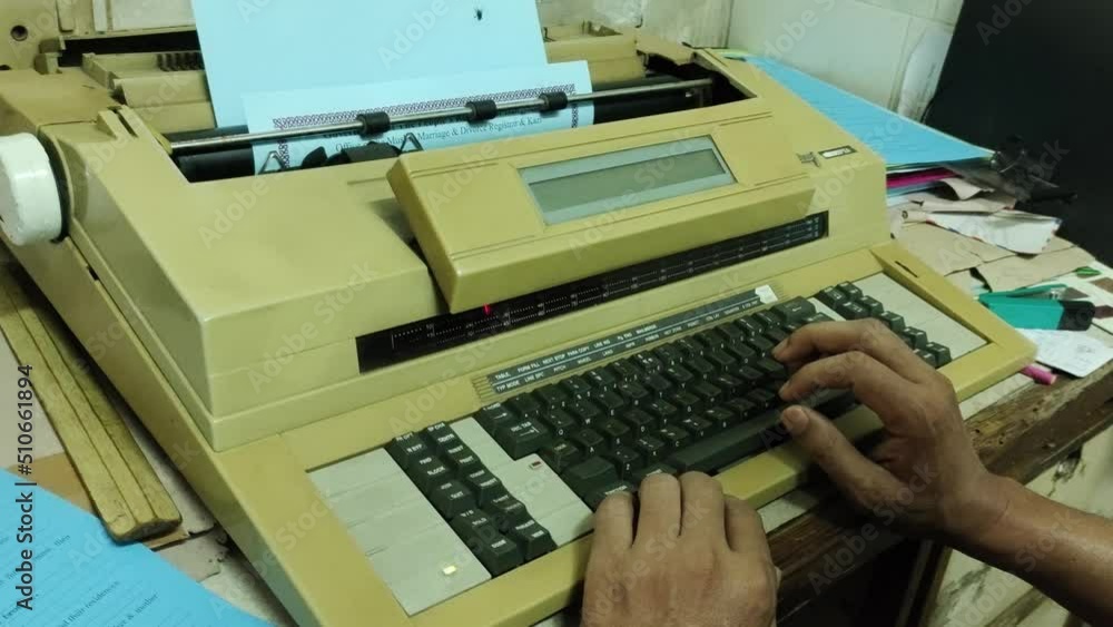A nostalgic or oldfashioned vintage electric typewriter is used by a