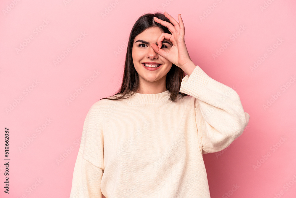 Young caucasian woman isolated on pink background excited keeping ok gesture on eye. Young caucasian woman isolated on pink background excited keeping ok gesture on eye.