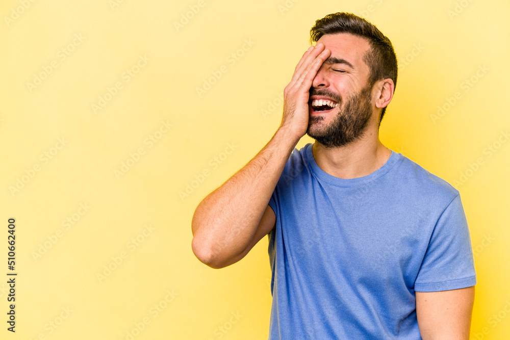 Young caucasian man isolated on yellow background laughing happy, carefree, natural emotion. Young caucasian man isolated on yellow background laughing happy, carefree, natural emotion.