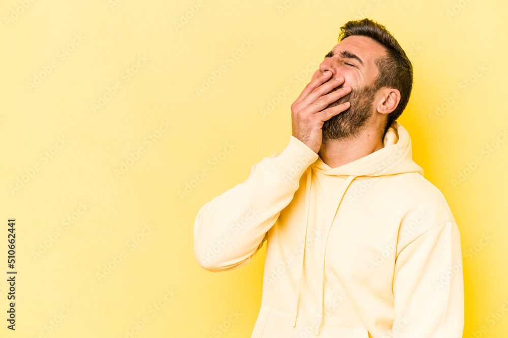 Young caucasian man isolated on yellow background laughing happy, carefree, natural emotion. Young caucasian man isolated on yellow background laughing happy, carefree, natural emotion.