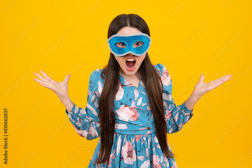 Fototapeta premium Teenager child girl in samba mask at carnival. Kids in carnival mask on birthday party, holidays concept. Excited face. Amazed expression, cheerful and glad.