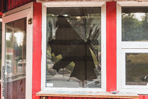 Broken window of a shop or home. Shattered glass of a construction