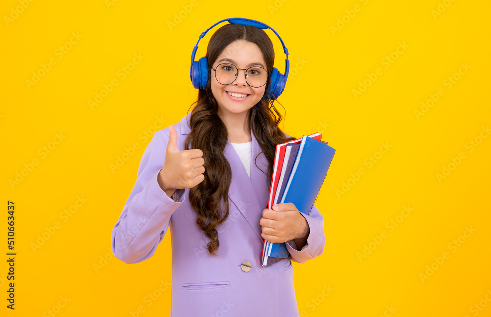 Student girl in headphones holding books. Education in school or college.