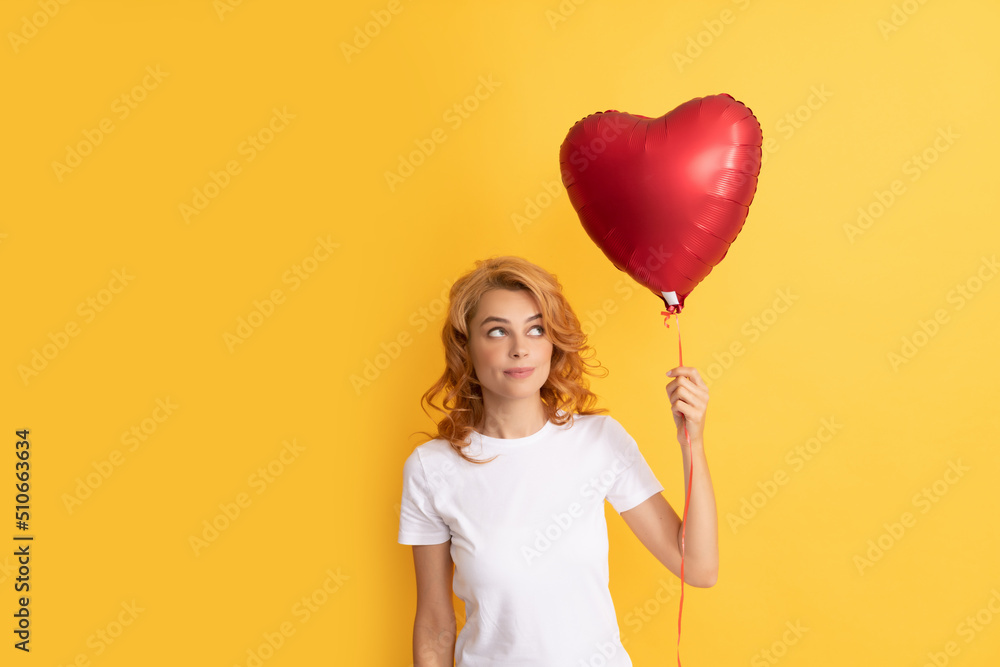 thoughtful redhead lady with romantic gift of party balloon. charity and donation thoughtful redhead lady with romantic gift of party balloon. charity and donation