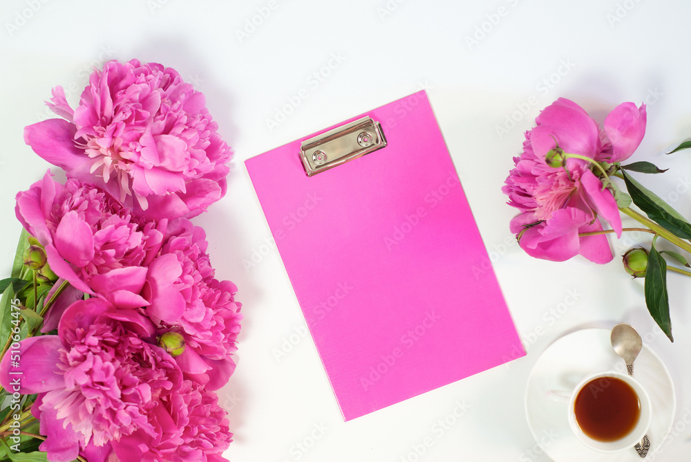 Flowers peonies and tablet for writing on a white background. Horizontal view. Flowers peonies and tablet for writing on a white background. Horizontal view.