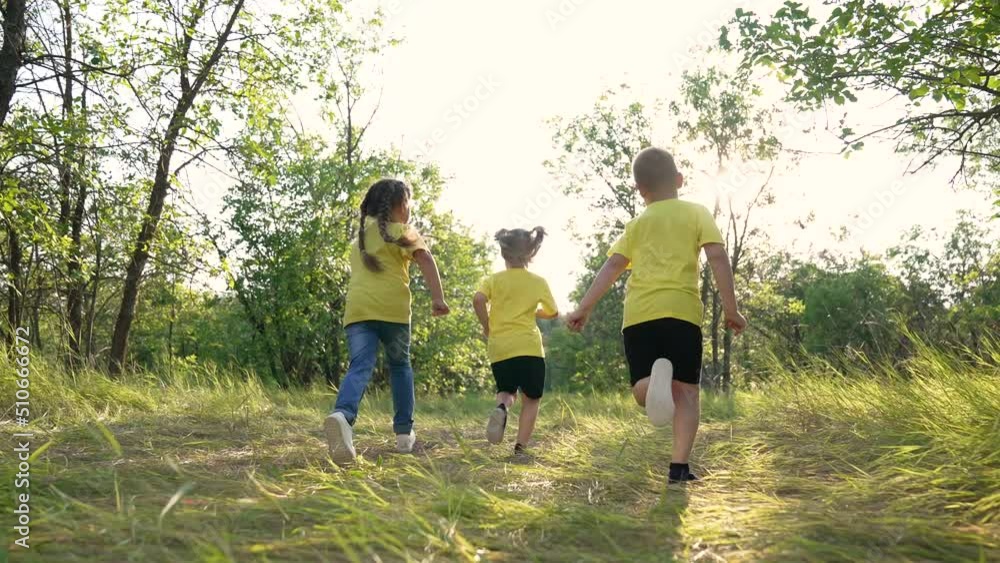 Happy family. Children play outdoors. Kids are playing on the green grass. Little children healthy lifestyle. Children dream. Children's education. Boy and girls study in park. Happy family concept Happy family. Children play outdoors. Kids are playing on the green grass. Little children healthy lifestyle. Children dream. Children's education. Boy and girls study in park. Happy family concept