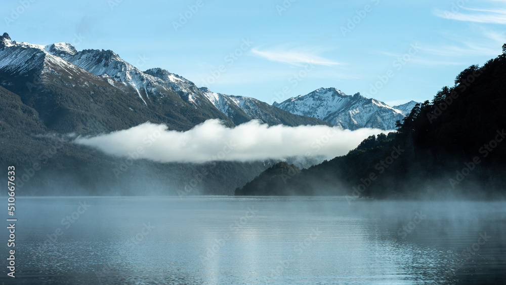 Sunrise with evaporation of a lake in the Andes mountain range. Lake Gutierrez, Los Alerces National Park