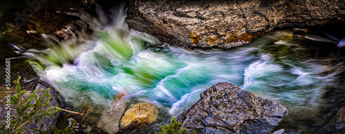 Obraz na plátně A colorful cascading stream among large rocks.