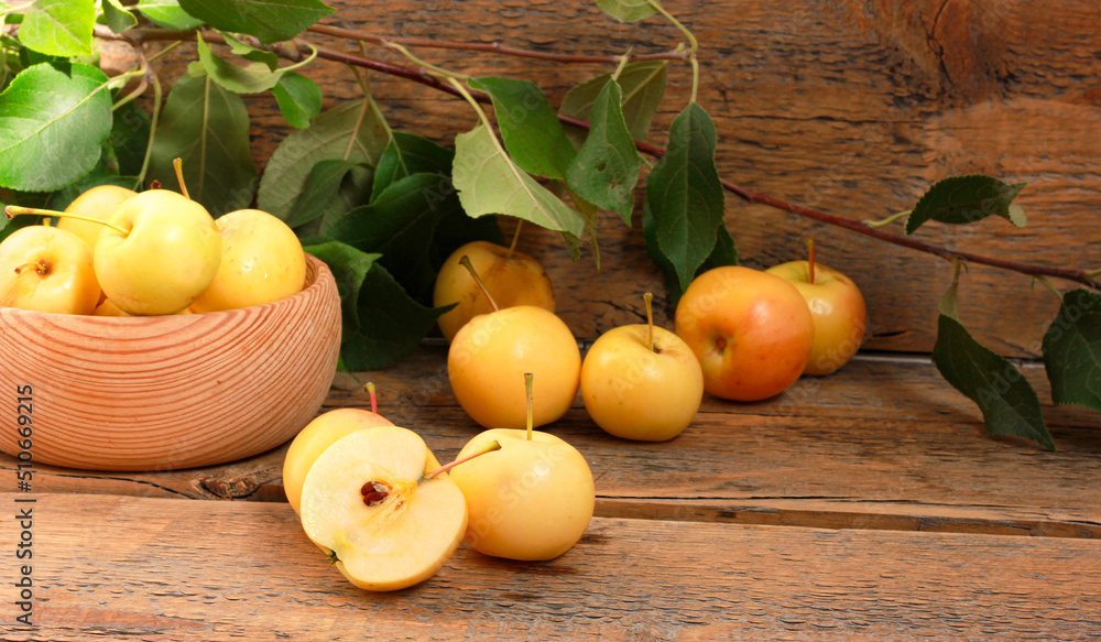 Golden ripe apples on a wooden background