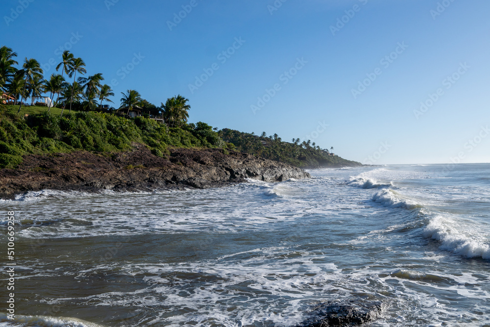Beautiful beach with rough seas and strong waves crashing against the rocks Beautiful beach with rough seas and strong waves crashing against the rocks