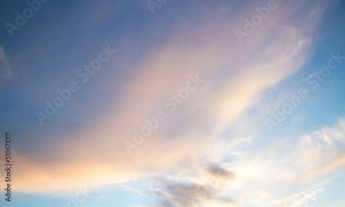 Summer sky. Cumulus clouds on a blue background. Partly cloudy.