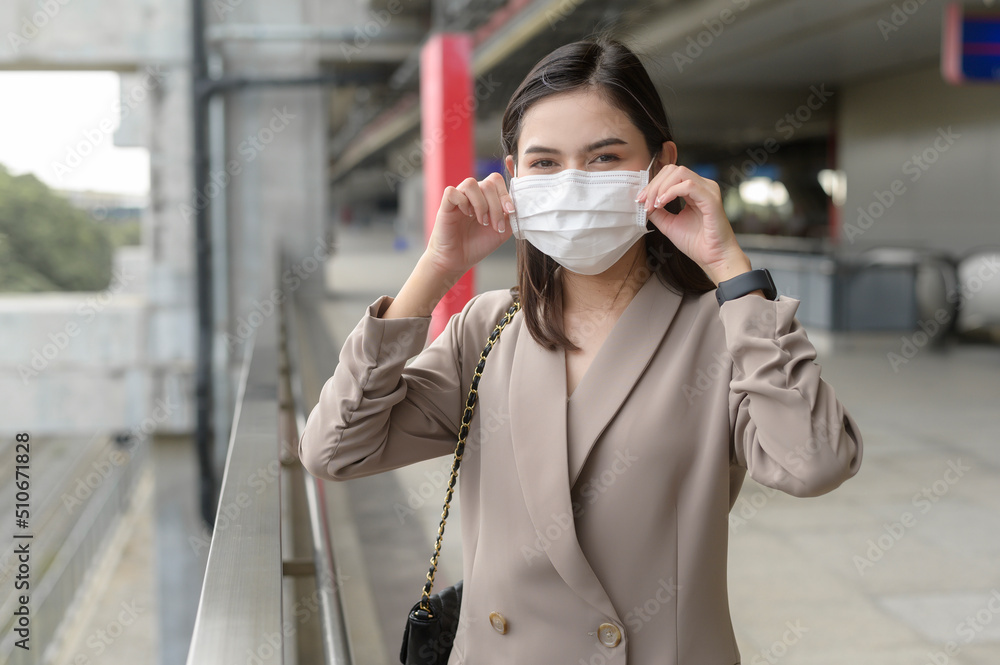 A portrait of Businesswoman is wearing face mask work in modern City , people lifestyle , working under Covid-19 pandemic concept A portrait of Businesswoman is wearing face mask work in modern City , people lifestyle , working under Covid-19 pandemic concept