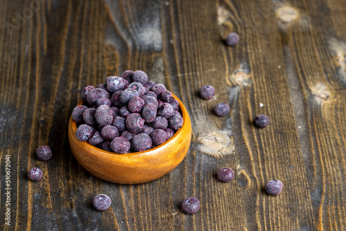 frozen blueberries on a wooden table