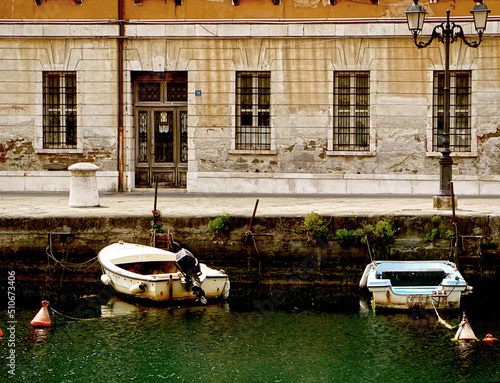 Trieste, Italy - cityscape with the ancient Palazzo Carciotti and the Canal Grande, navigable canal in city center built in 18th century. photo