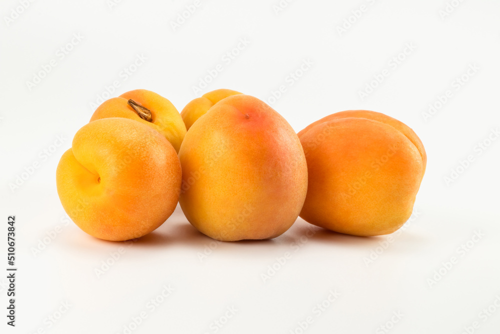 A group of apricot fruit isolated on bright background. Close up view. A group of apricot fruit isolated on bright background. Close up view.