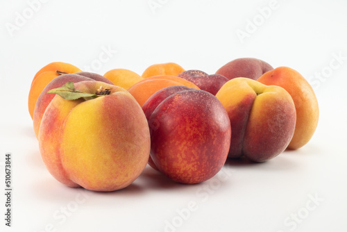 Peaches, nectarines and apricots on bright background. Close up view.