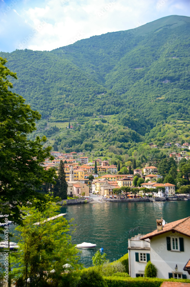 Scenic view in Como lake, Italy with waterfront town and mountain in the back. Summer holidays and travel destination in Europe for relaxation and romance