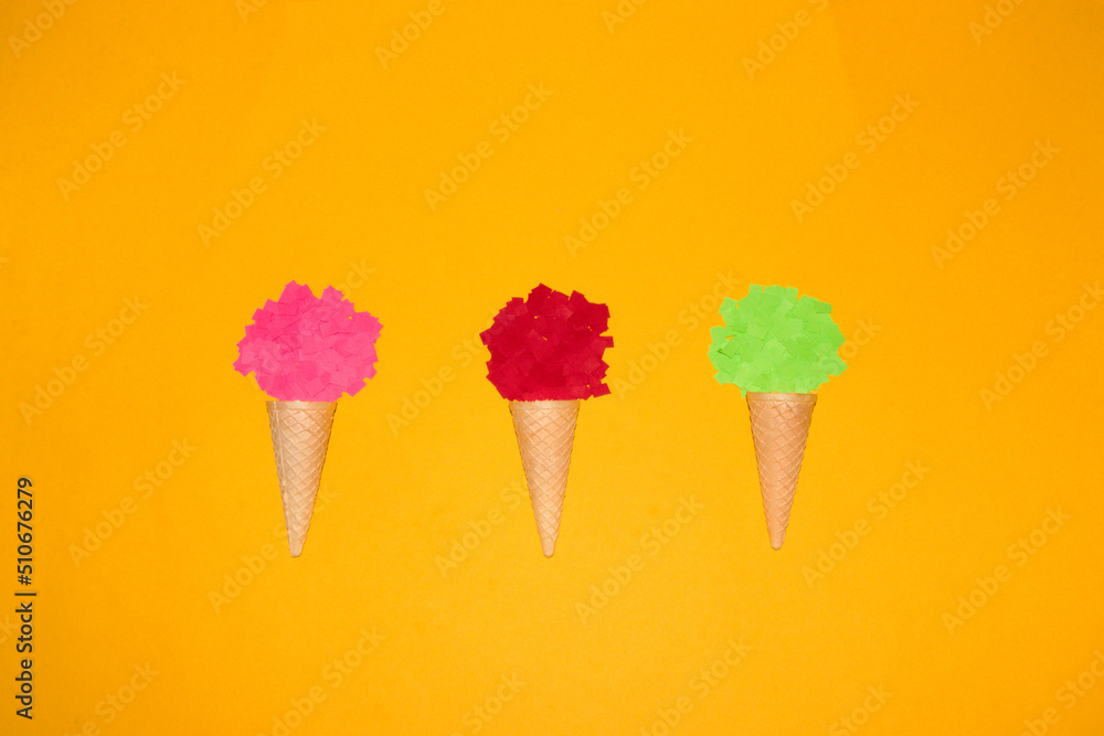 three ice cream cones, one with pink, another with red and a third with a green paper ball, creative art design, summer concept three ice cream cones, one with pink, another with red and a third with a green paper ball, creative art design, summer concept