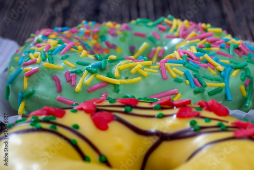sweet donut in yellow and green chocolate with filling