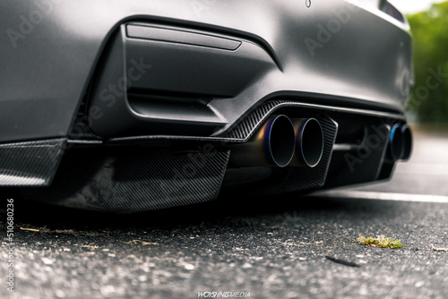 Quad tip exhaust on a grey car