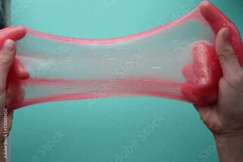 Pink slime in hands.