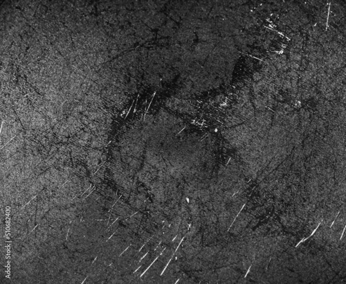 Grunge black texture. The texture of the scratches on the metal. Texture scratches background monochrome. Rough textured hard background. The surface is damaged.