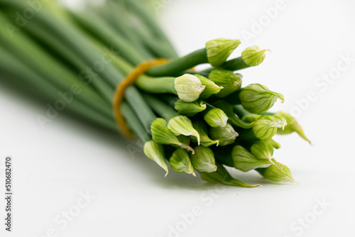 Fresh garlic chives close up isolated on white background