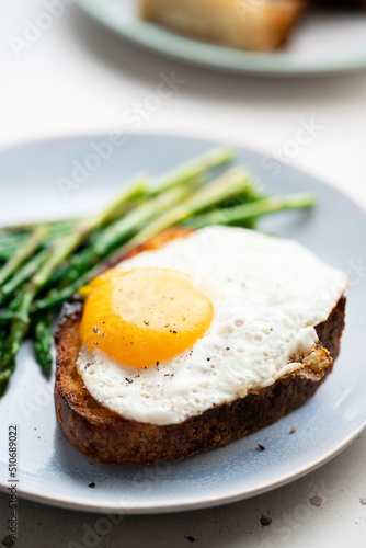 Fried eggs with toasted bread and green asparagus. Fast lunch ideas  healthy breakfast  summer food.