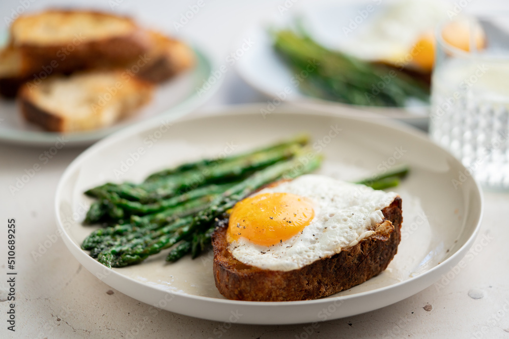 Fried eggs with toasted bread and green asparagus. Fast lunch ideas, healthy breakfast, summer food. Fried eggs with toasted bread and green asparagus. Fast lunch ideas, healthy breakfast, summer food.