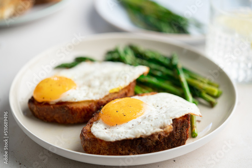 Fried eggs with toasted bread and green asparagus. Fast lunch ideas, healthy breakfast, summer food.