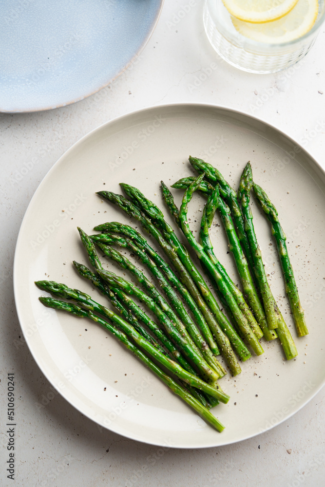 Grilled green asparagus on a a plate, top view. Grilled green asparagus on a a plate, top view.