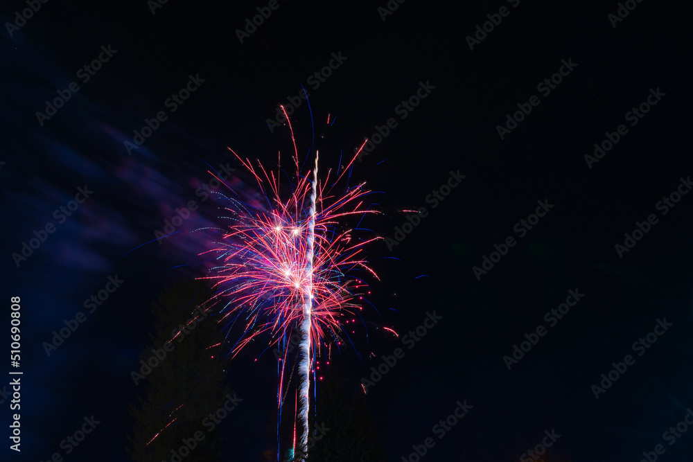 Beautiful festive red fireworks against the background of the night sky Beautiful festive red fireworks against the background of the night sky