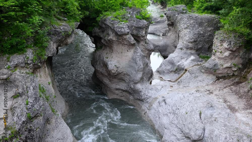 Stunning landscape in the Khadzhokh gorge. The narrow part of the gorge and the Belaya River. Kamennomostsky canyon. Bubbling mountain river Belaya. Adygea. Stunning landscape in the Khadzhokh gorge. The narrow part of the gorge and the Belaya River. Kamennomostsky canyon. Bubbling mountain river Belaya. Adygea.