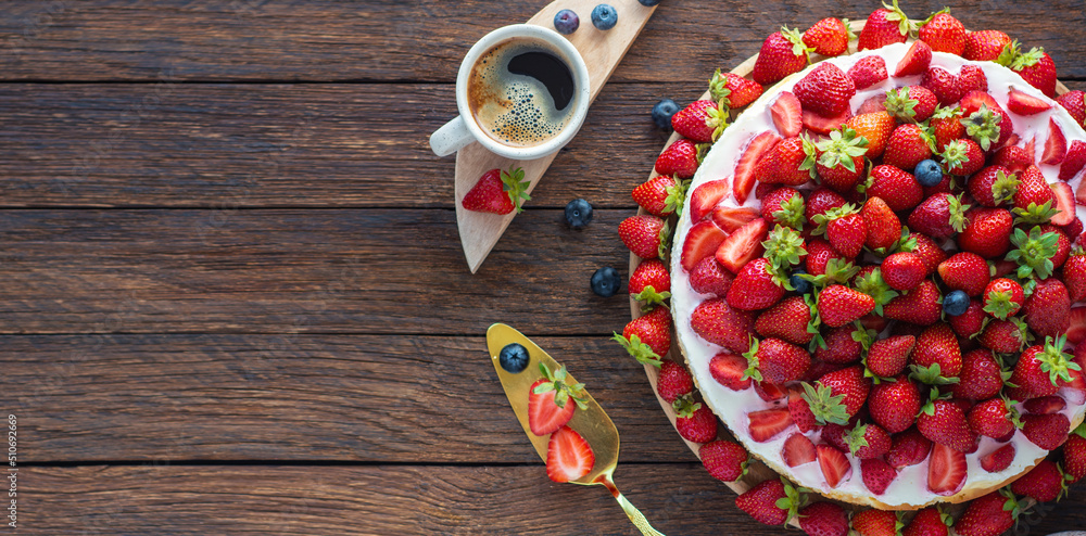 vanilla coconut cheesecake, decorated with fresh strawberries, a cup of aroma coffee on a table
